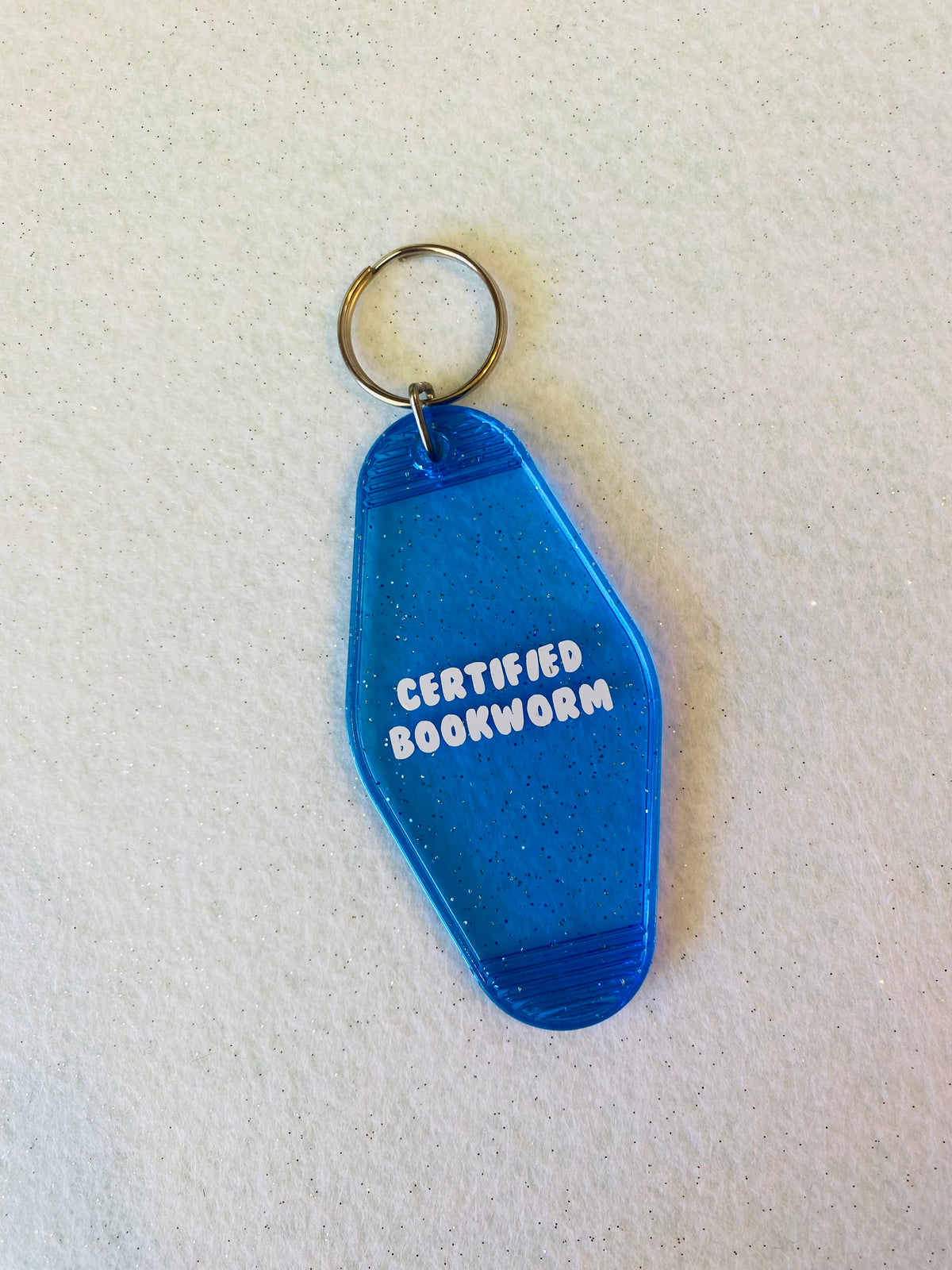 Certified Bookworm Blue Glitter Acrylic Motel Keychain
