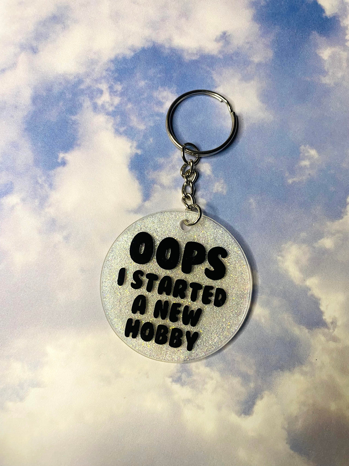 Oops I Started a New Hobby White Glitter Acrylic Circle Keychain